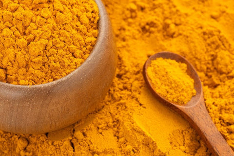 turmeric powder in a wooden bowl